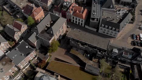 top down reveal of historic bourgonje stronghold tower and city wall among the new and old parts of the dutch medieval hanseatic cityscape of zutphen