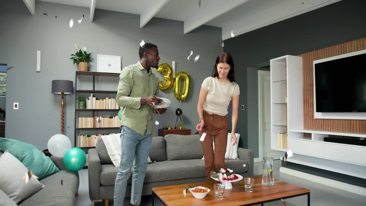 Couple smiling while confetti falling, standing and preparing to serve 30th cake and plates