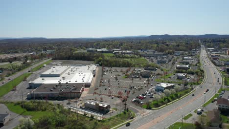 4K-Aerial-Drone-footage-of-industrial-shopping-centers-and-strip-malls-in-Middletown-New-York-and-traffics-can-be-seen-with-mountains-in-the-background