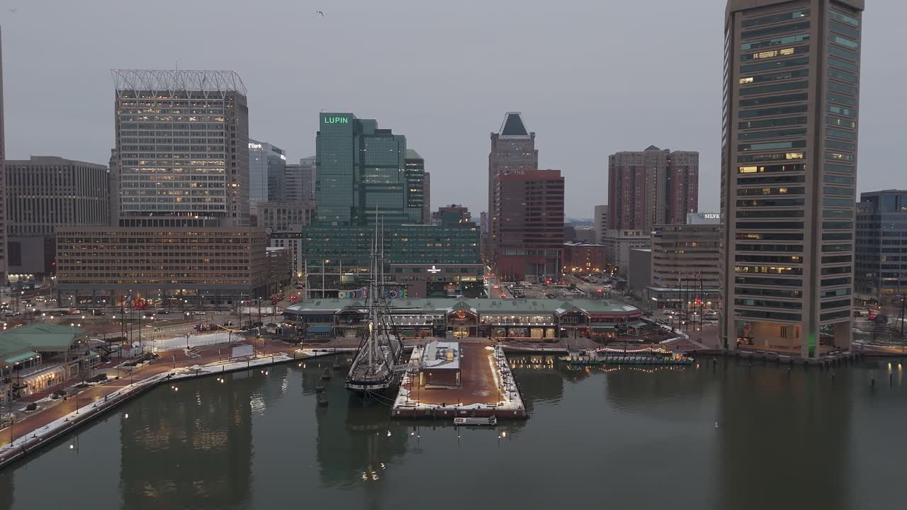 Historic ship in Baltimore inner harbour, dusk overcast weather, drone view