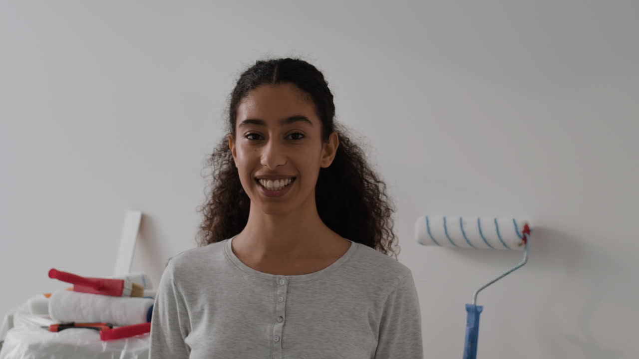 Happy Young Woman Painting Her Home