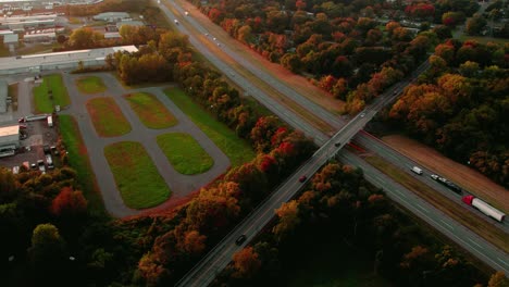 Incredible-aerial-of-trucking-logistics-business,-semi-truck-drivers-on-interstate