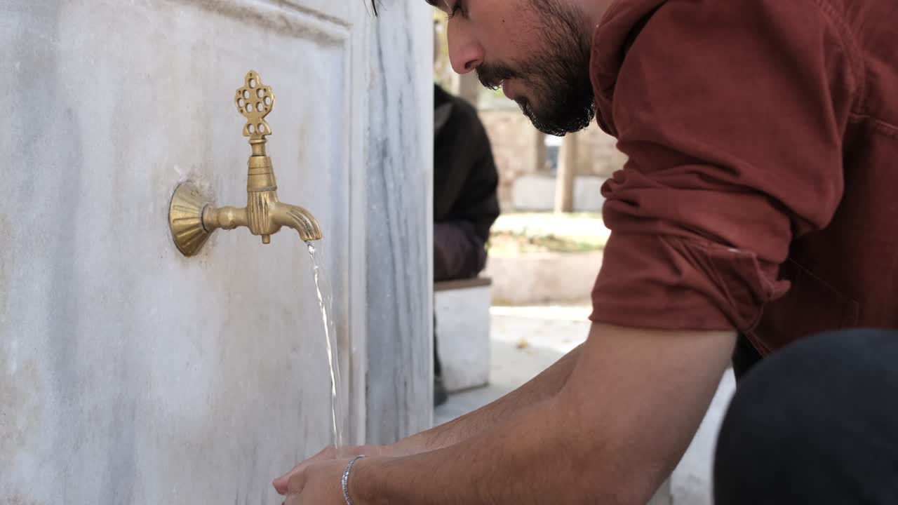 Man Ablution at Fountain to Praying