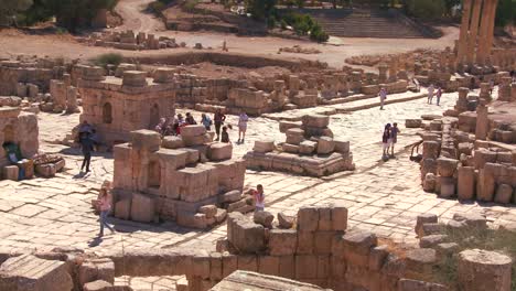 tourists walk amongst the ruins of jerash jordan