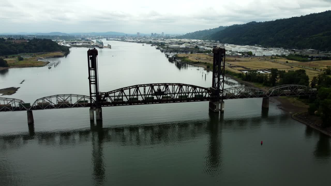 US, Oregon, Portland, St Johns, 2025-07-26 - Drone view of a freight train going across the Train Bridge