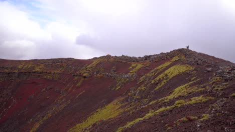 people at the edge of a crater