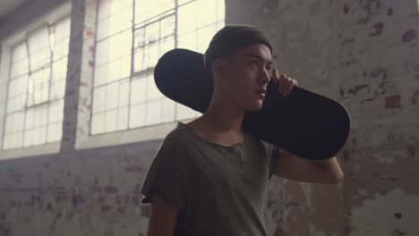 fashionable young man in an abandoned warehouse