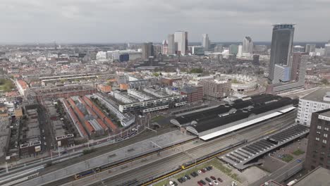 Rising-drone-shot-of-The-Hague-HS-railway-station-and-central-business-area