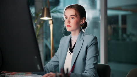 a businesswoman working at her computer in an office
