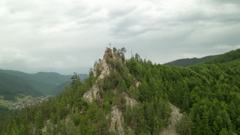 4K-drone-footage-circling-around-a-top-of-a-hill-with-a-Christian-cross-near-Osrblie,-Central-Slovakia,-Europe