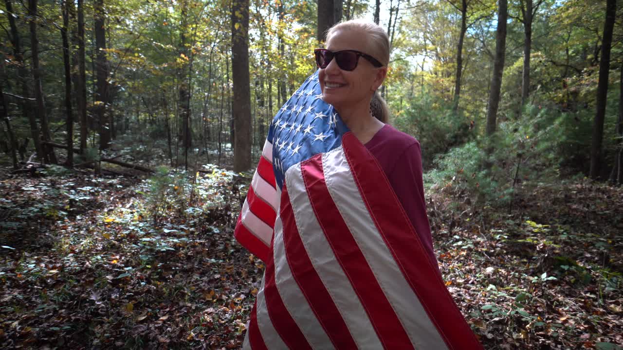 Woman with American flag in forest