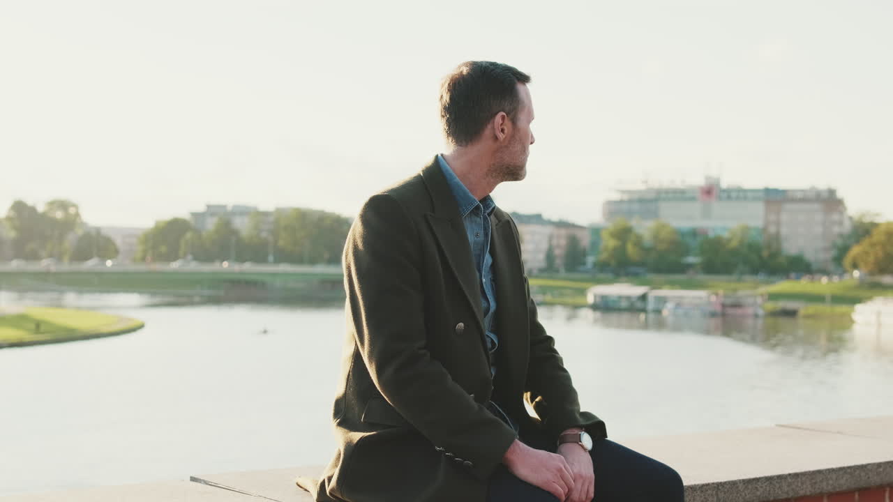 Man sitting by the river in the city