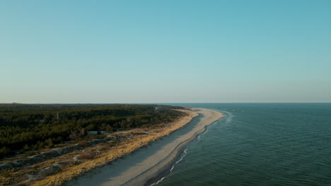 beautiful drone flight over waves crashing on beach coast in hel poland