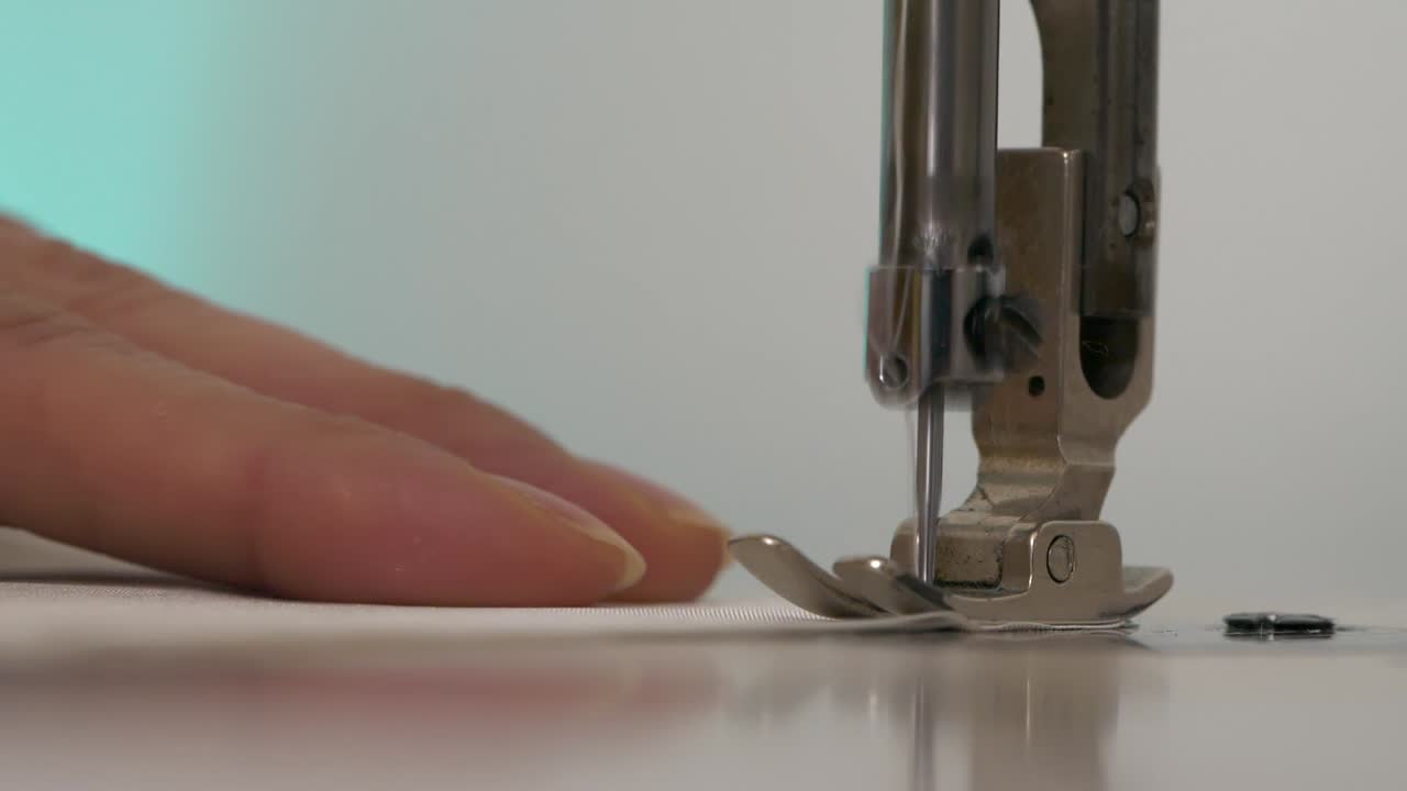 Hand of woman working with sewing machine