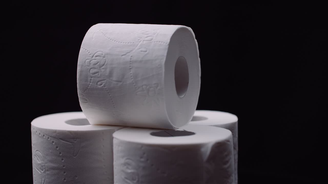 Toilet Paper Isolated on Black Background Rotating.