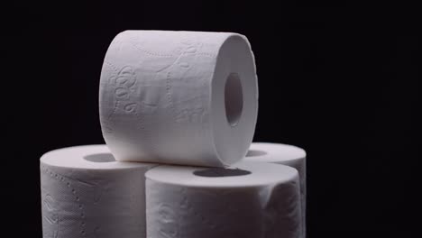 toilet paper isolated on black background rotating.