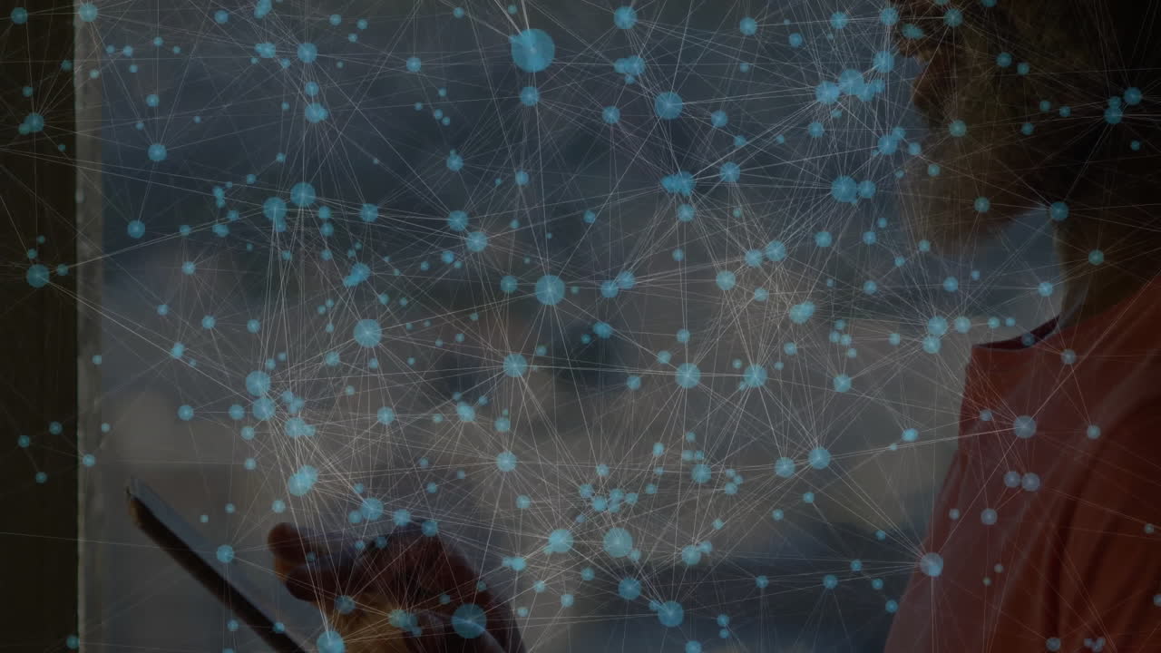 Using tablet, person viewing network connections and data processing overlay