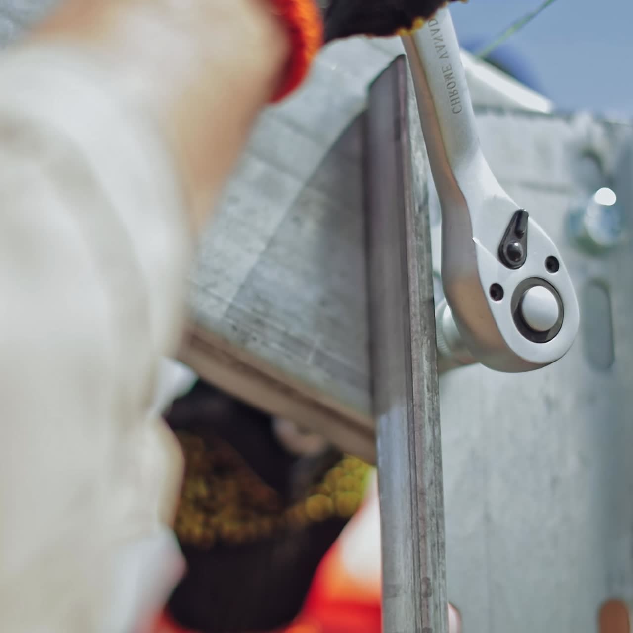 Metal frame installation. Hand of a worker is fixing metal basis for photovoltaic solar panel. Close-up.