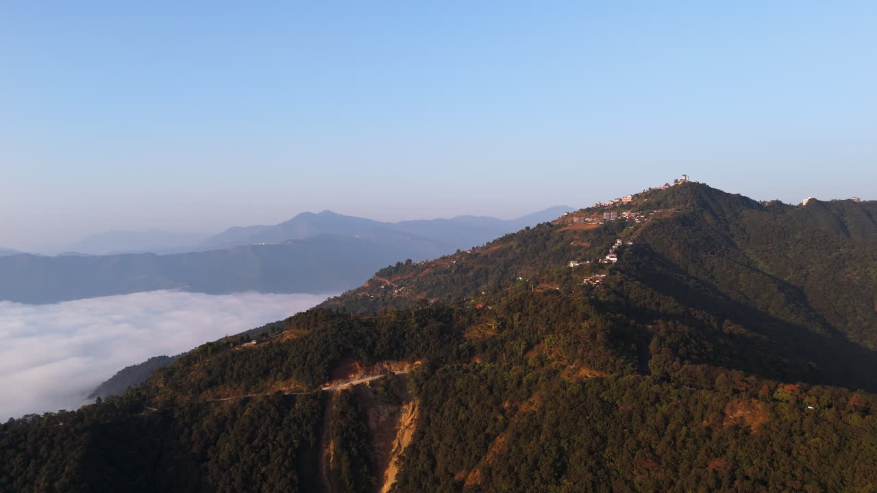 Panoramic drone shot of the Sarangkot mountain, misty sunrise in Pokhara, Nepal