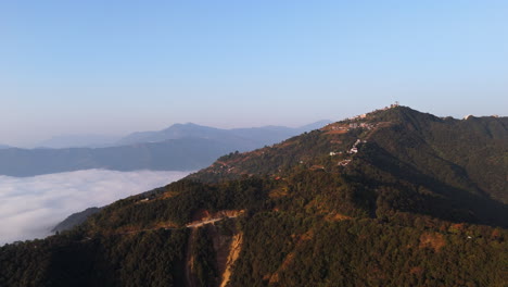 panoramic drone shot of the sarangkot mountain, misty sunrise in pokhara, nepal