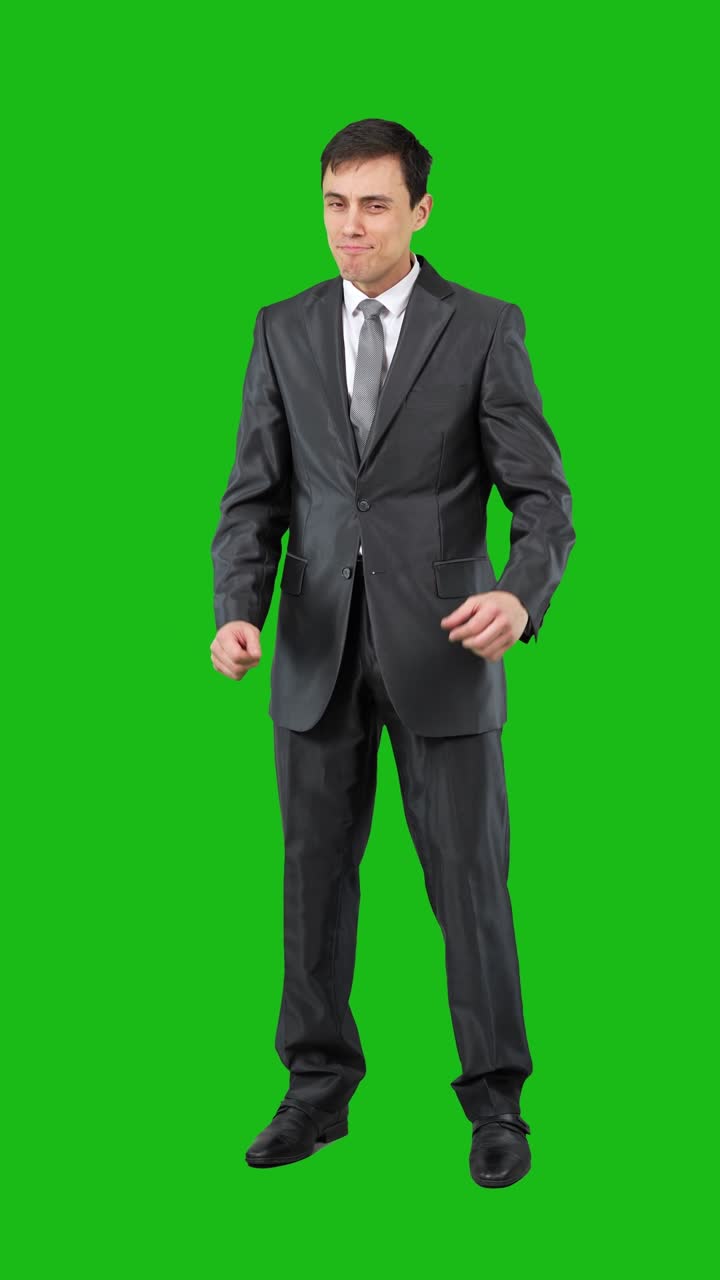 Man in a suit expressing various emotions on a green screen