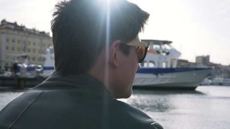 man looking at a ship in a port