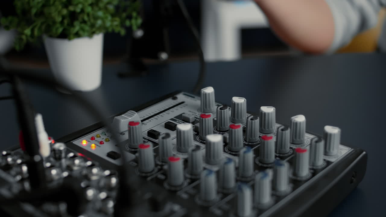 Internet famous star tweaking audio mixer knobs and buttons
