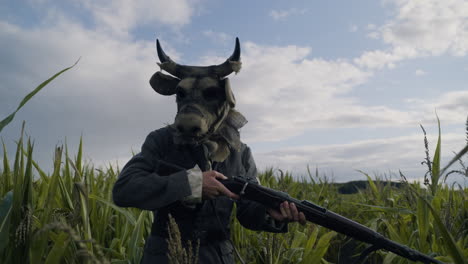 soldier with animal mask in cornfield