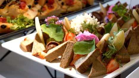 Platter with p&acirc;t&eacute;, adorned with strawberries, chanterelles, and apple slices