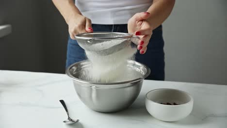 woman sifting flour for baking