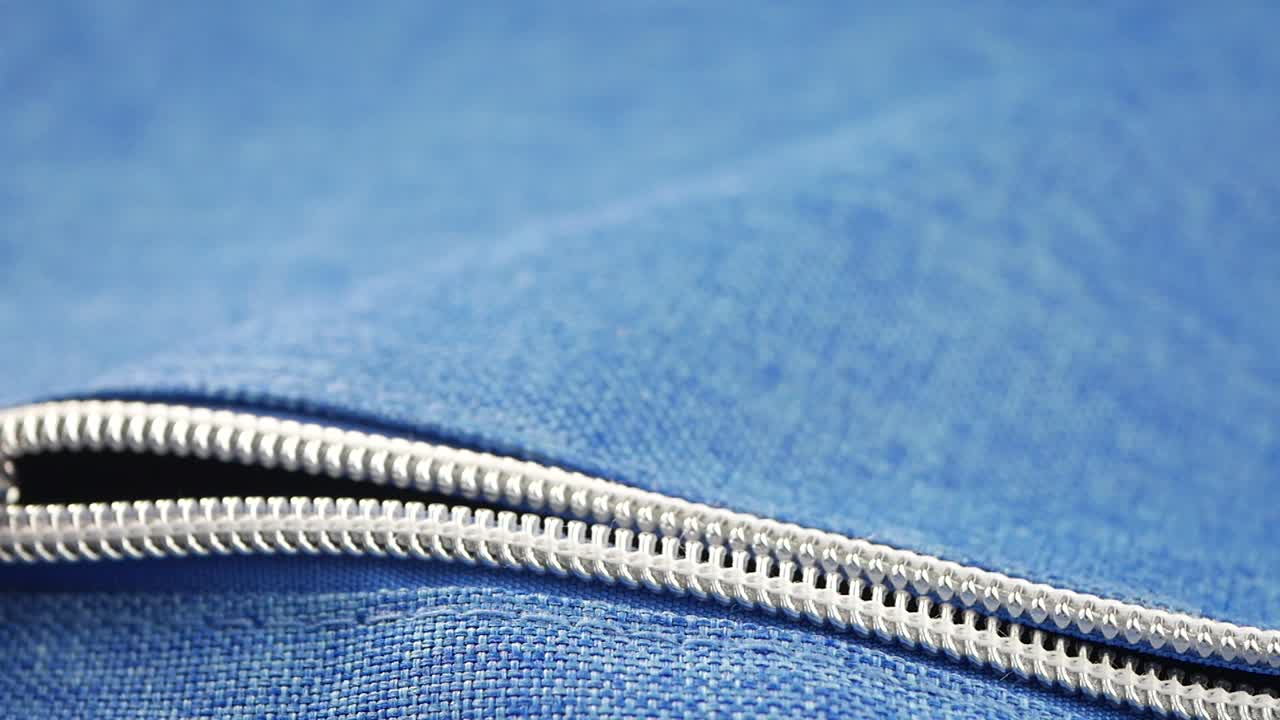 Close-up of a zipper on blue fabric