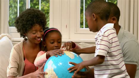 Happy-family-holding-globe-