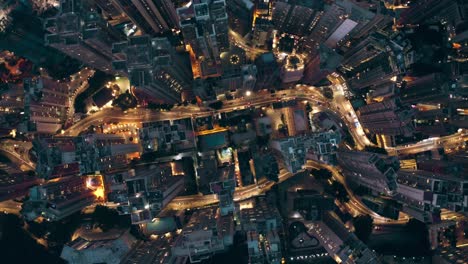 drone shot of a city full of skyscrapers view from a bird during the night, a lot of roads with busy traffics