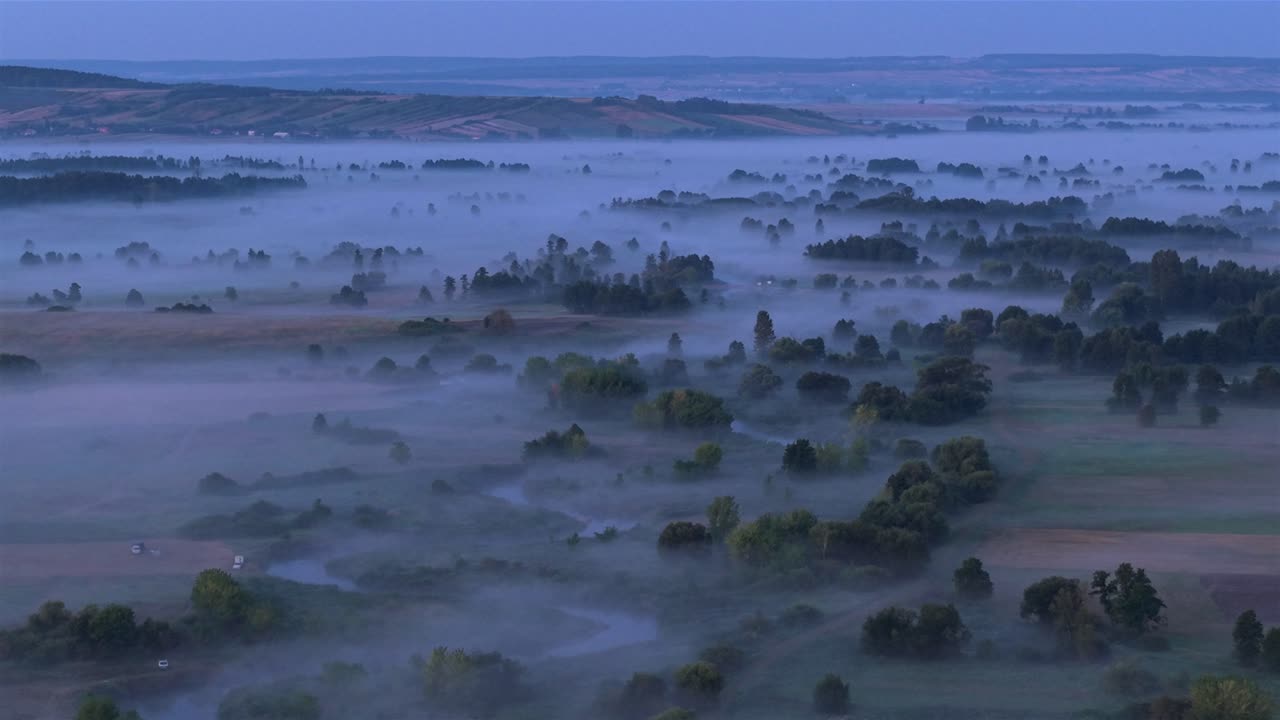 Aerial view of foggy Nida river, people camping, nature in Poland