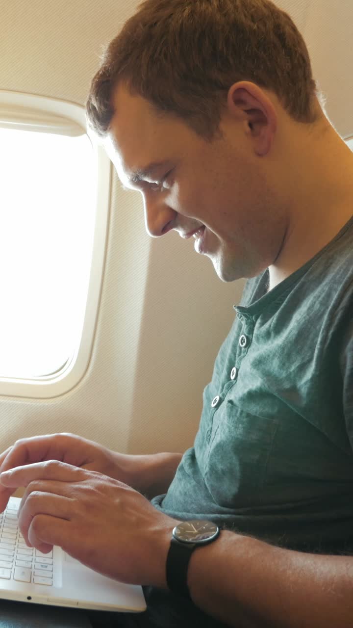 Man working on laptop during flight
