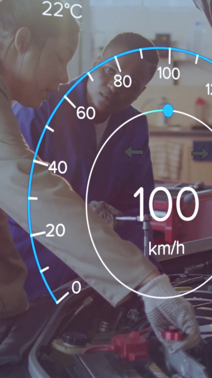 Vertical video: Two techs tightening battery clamp as HUD rising speed initiating test in garage