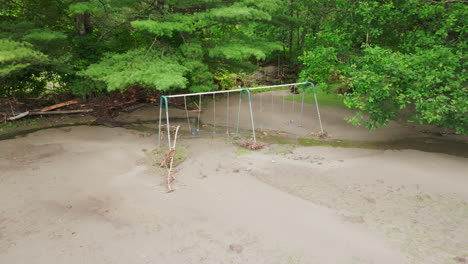 aftermath of flooding: aerial footage of a playground damaged by the river and debris, vermont