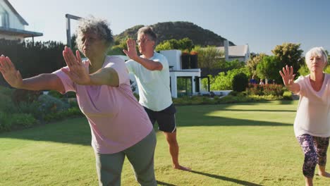 senior diverse people exercising in garden on sunny day at retirement home