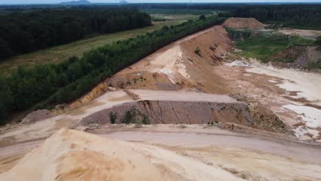 Sand-dunes-in-local-quarry-of-Limburg,-Netherlands,-aerial-view