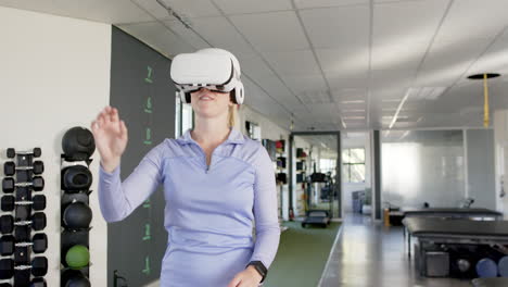 using vr headset, woman in rehabilitation center engaging in virtual therapy