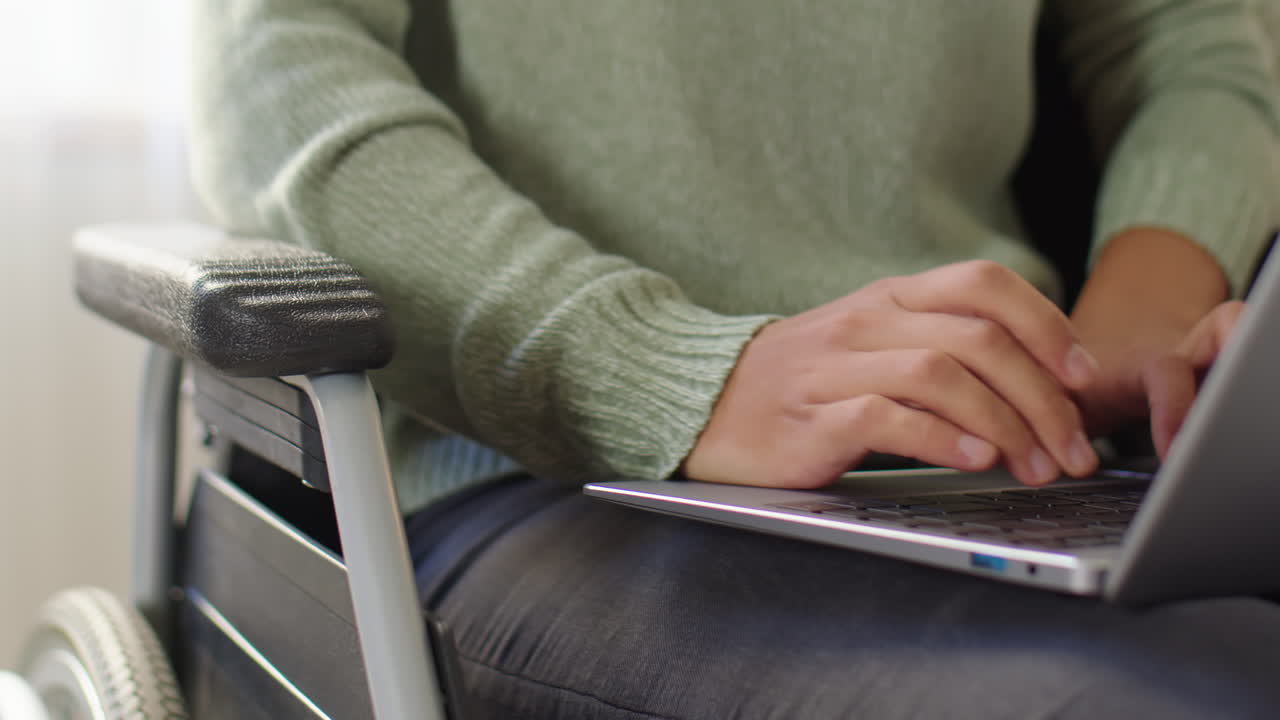 Person using laptop in wheelchair