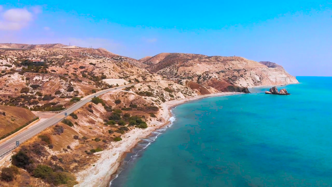 Wide aerial shot of the coast of Paphos with Aphrodite's Rock in Paphos Cyprus