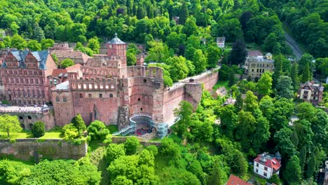 4k aerial drone video of ruins of historic castle on königstuhl hill overlooking heidelberg, germany