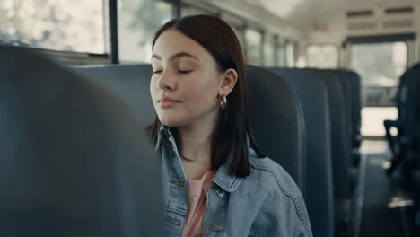 teenage girl sitting schoolbus alone. cute student looking window on daily ride.