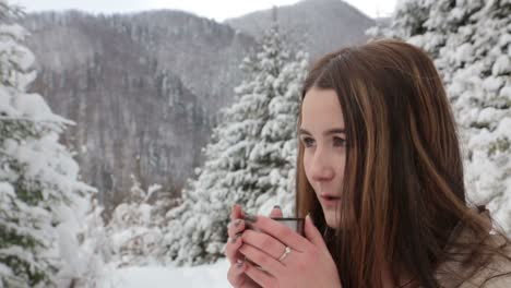 young pretty girl drinks hot tea on the date in winter forest young pretty girl drinks hot tea on the date in winter forest