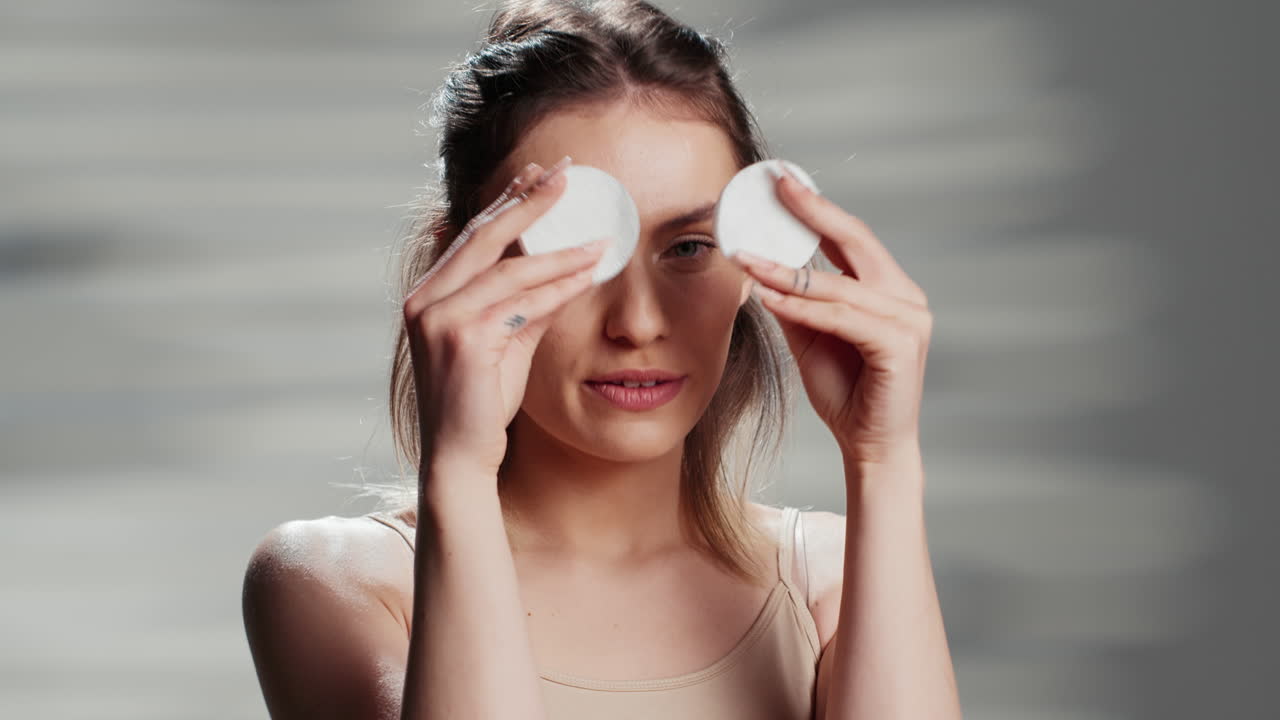 Woman using cotton pads for skincare
