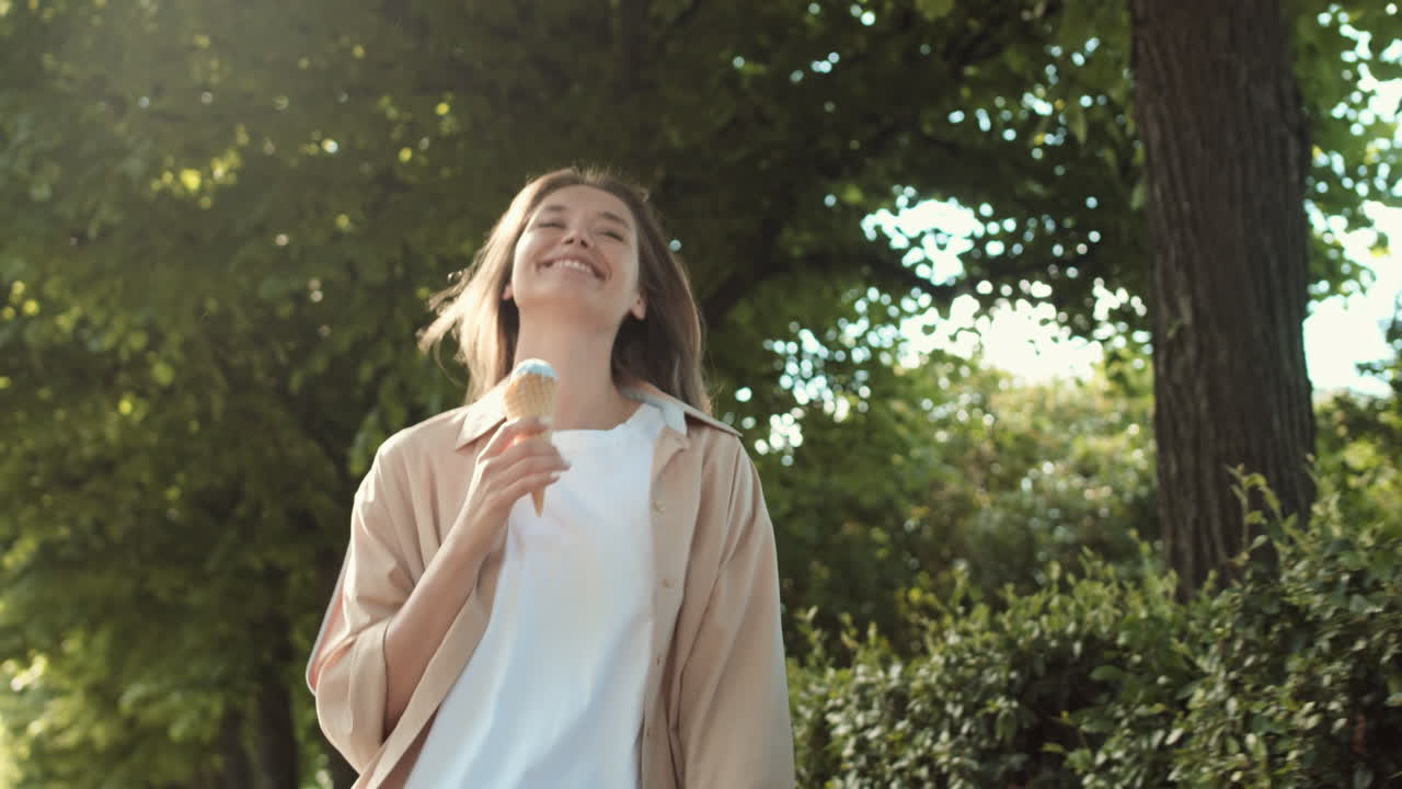 Woman Walking with Icecream in Park