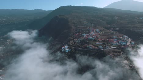 Beautiful-Aerial-Pull-Back-Shot-of-Cloudy-Mountain-Village-in-Spain,-Anaga-Mountains