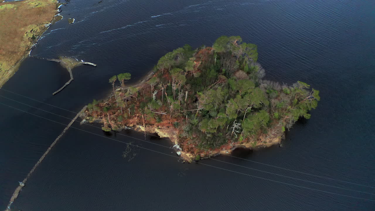 Dynamic top-down aerial shot of Pine Island in Connemara National Park.