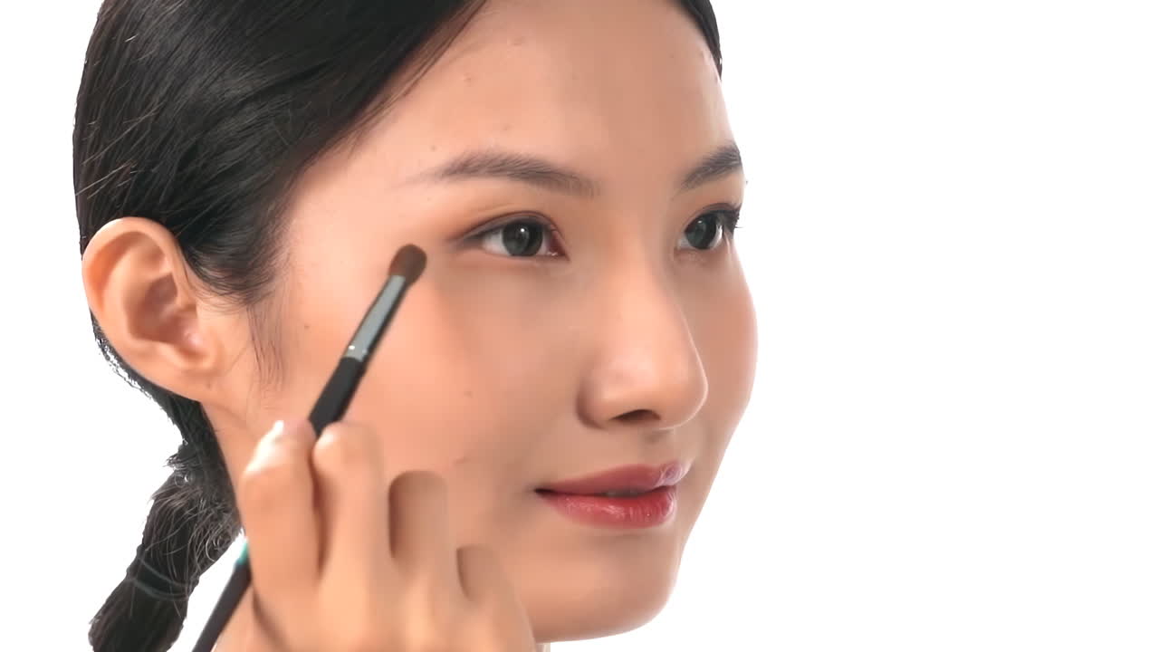 Professional young girl with lots of makeup brushes, surrounded by a variety of cosmetics, eyeshadows and lipsticks